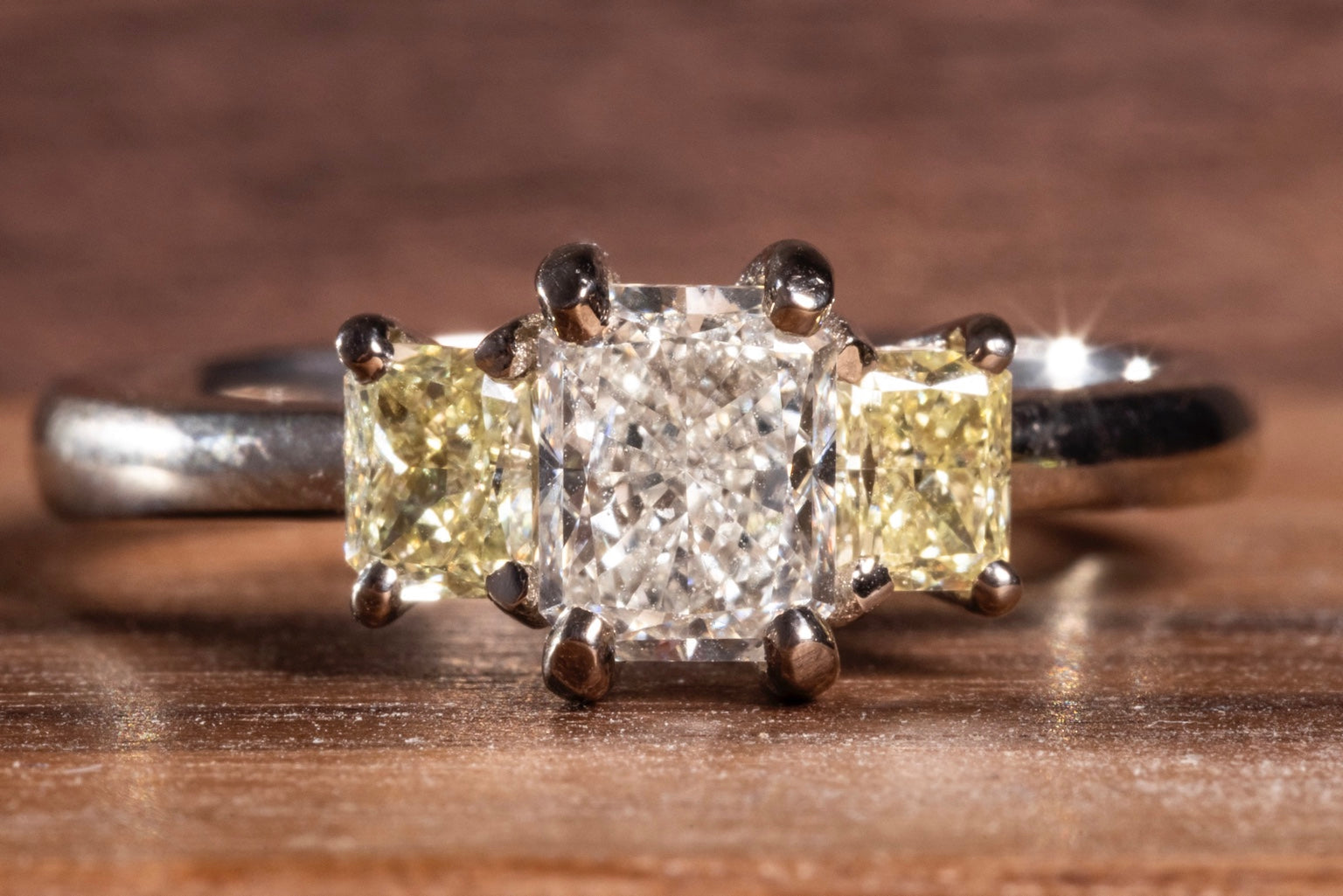 Jewellery By Design NZ three-stone diamond engagement ring with yellow diamond side stones
