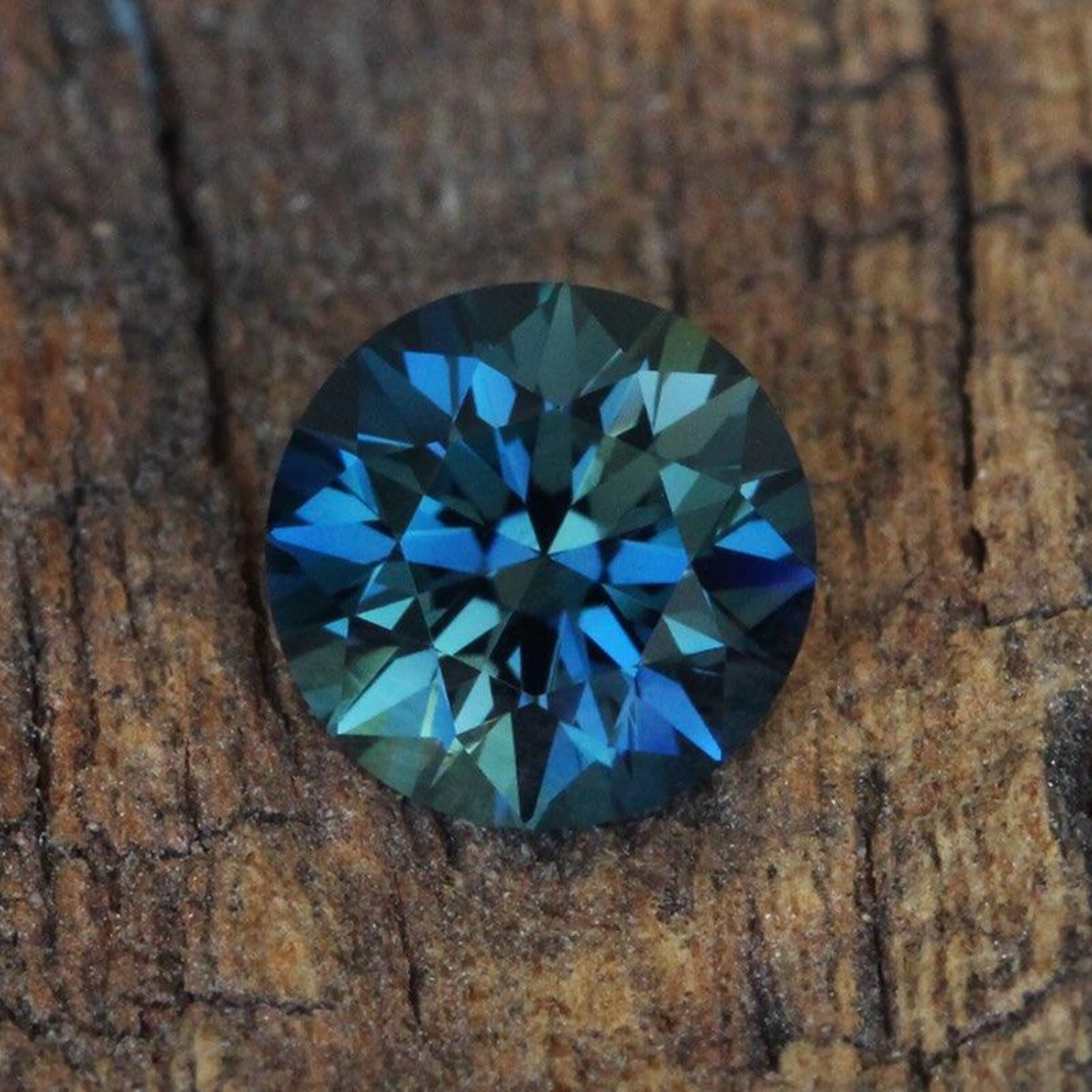 Blue gemstone on a wooden surface