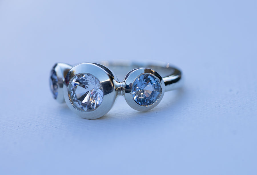 1ct White Sapphire with 2 Blue Sapphires in 9ct White Gold